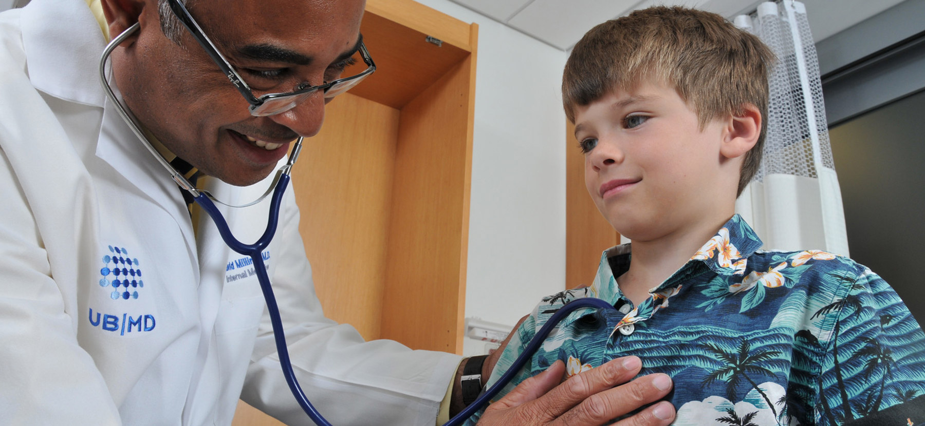 Doctor listening to child's heart
