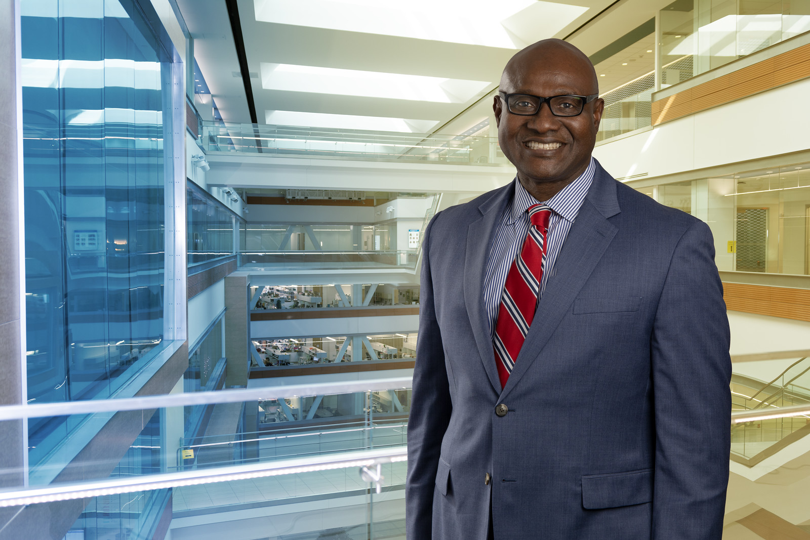 Dr. Leonard Egede in a blue suit and red striped tie in the Department of Medicine building
